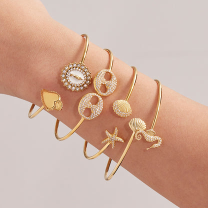 Gold 5A zircon ocean bangle stack on wrist, minimalist luxury beach jewelry