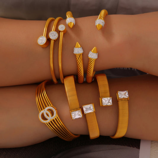 Gold open cuff bangles stacked on wrist