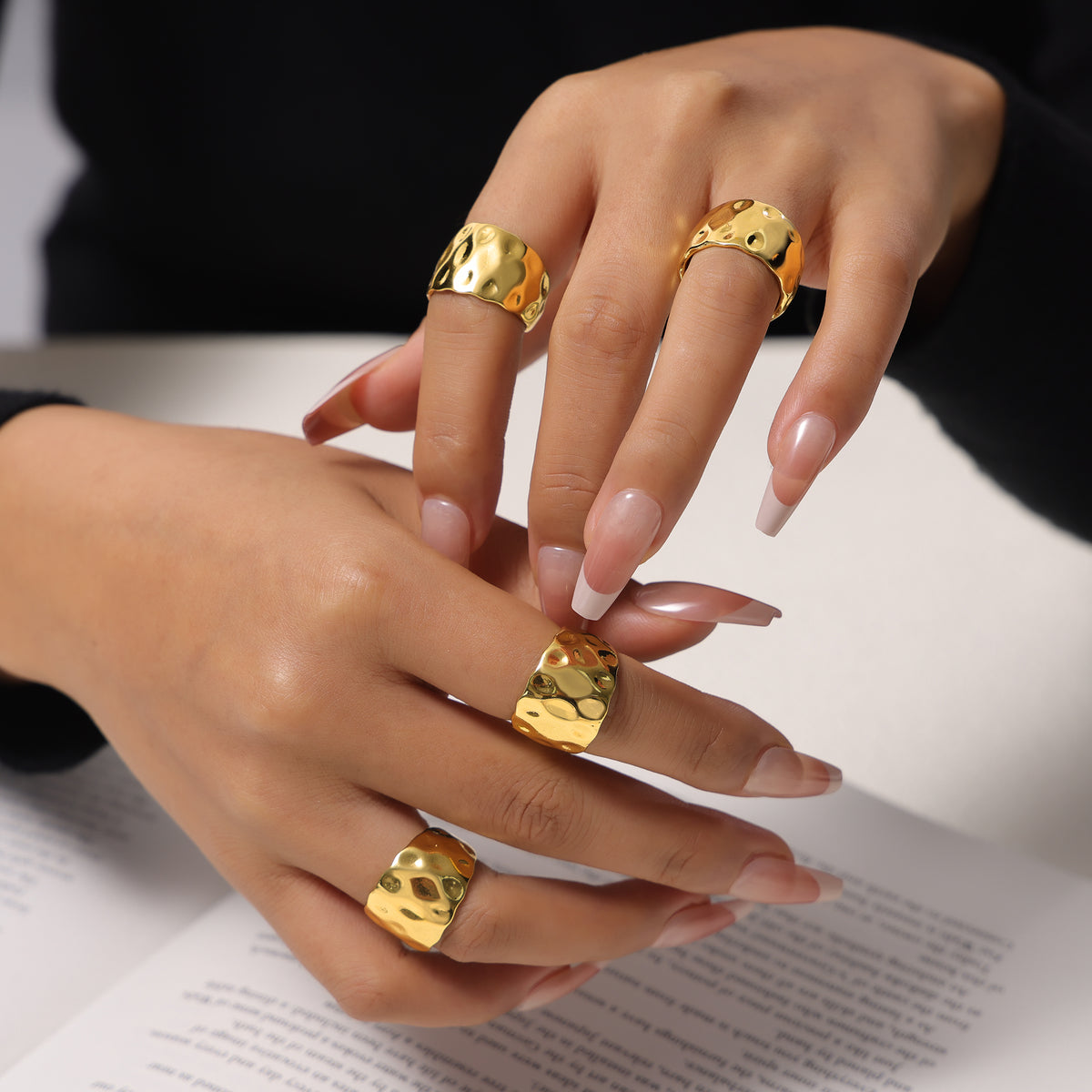 Gold open rings with sculptural hammered texture styled on hand