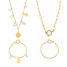 Gold paperclip charm necklace and bracelet variants with coin, checkerboard and pearl-look charms