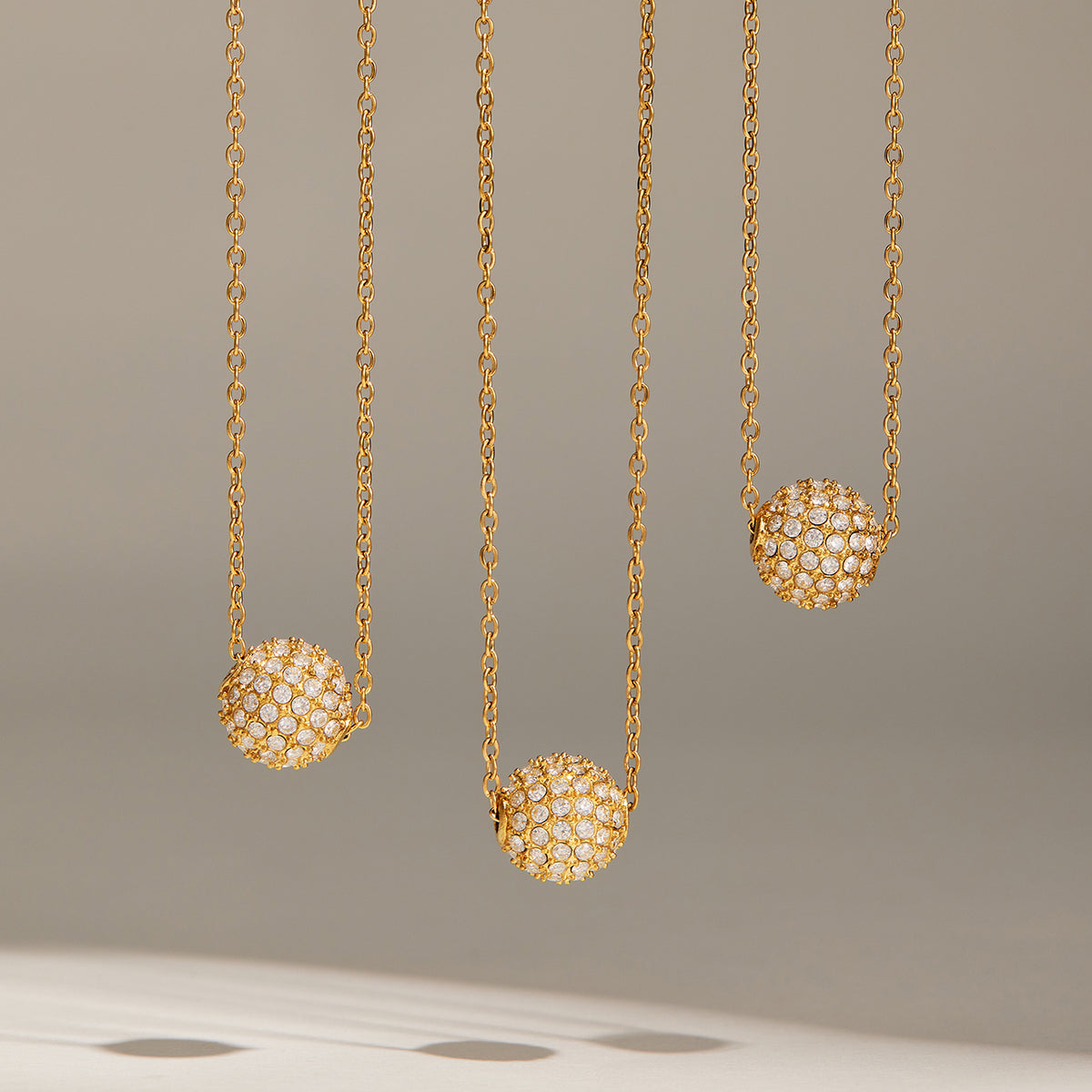 Gold-tone pavé zircon ball necklaces in 8 mm and 10 mm sizes