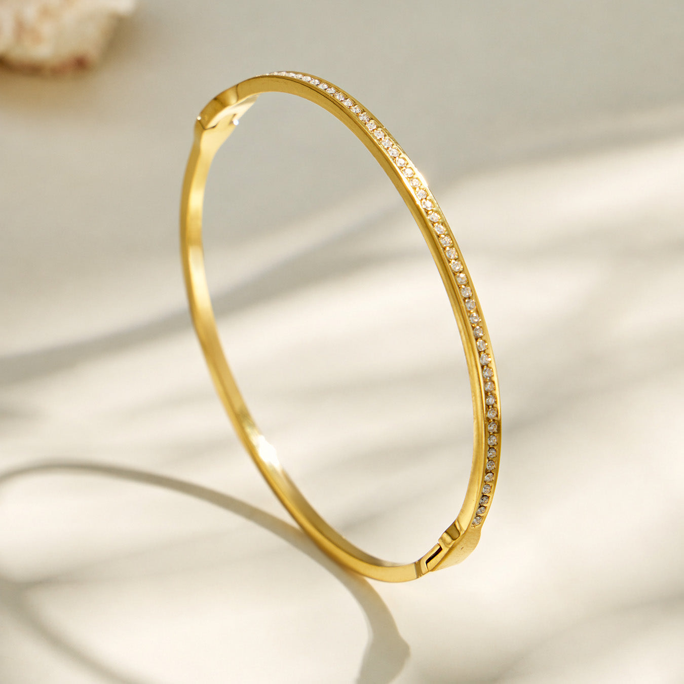 Slim gold bangle bracelet with a continuous pavé zircon design