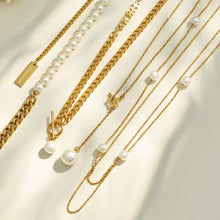 Gold faux pearl and layered necklaces displayed together in a wholesale style assortment