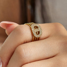 Close-up of a gold rectangular cubic zirconia open ring worn on a model finger