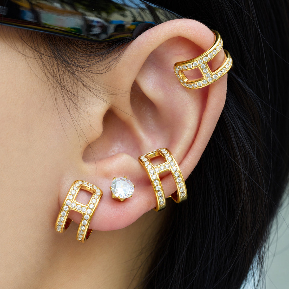 Gold-tone stainless steel rhinestone clip-on ear cuffs styled on ear without traditional pierced posts