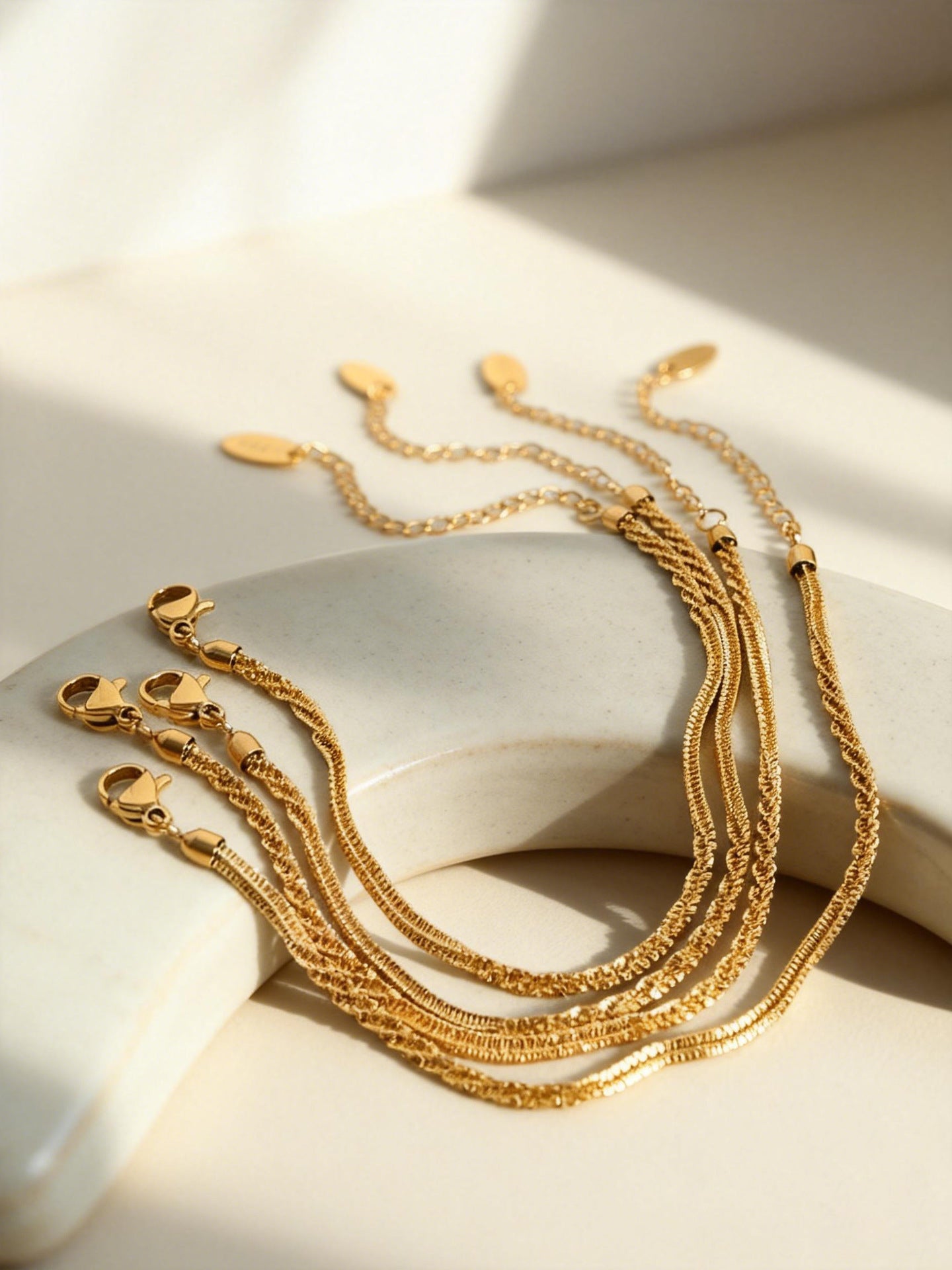 Gold rope chain bracelets flat lay with lobster clasp and extender chain for wholesale stainless steel jewelry buyers
