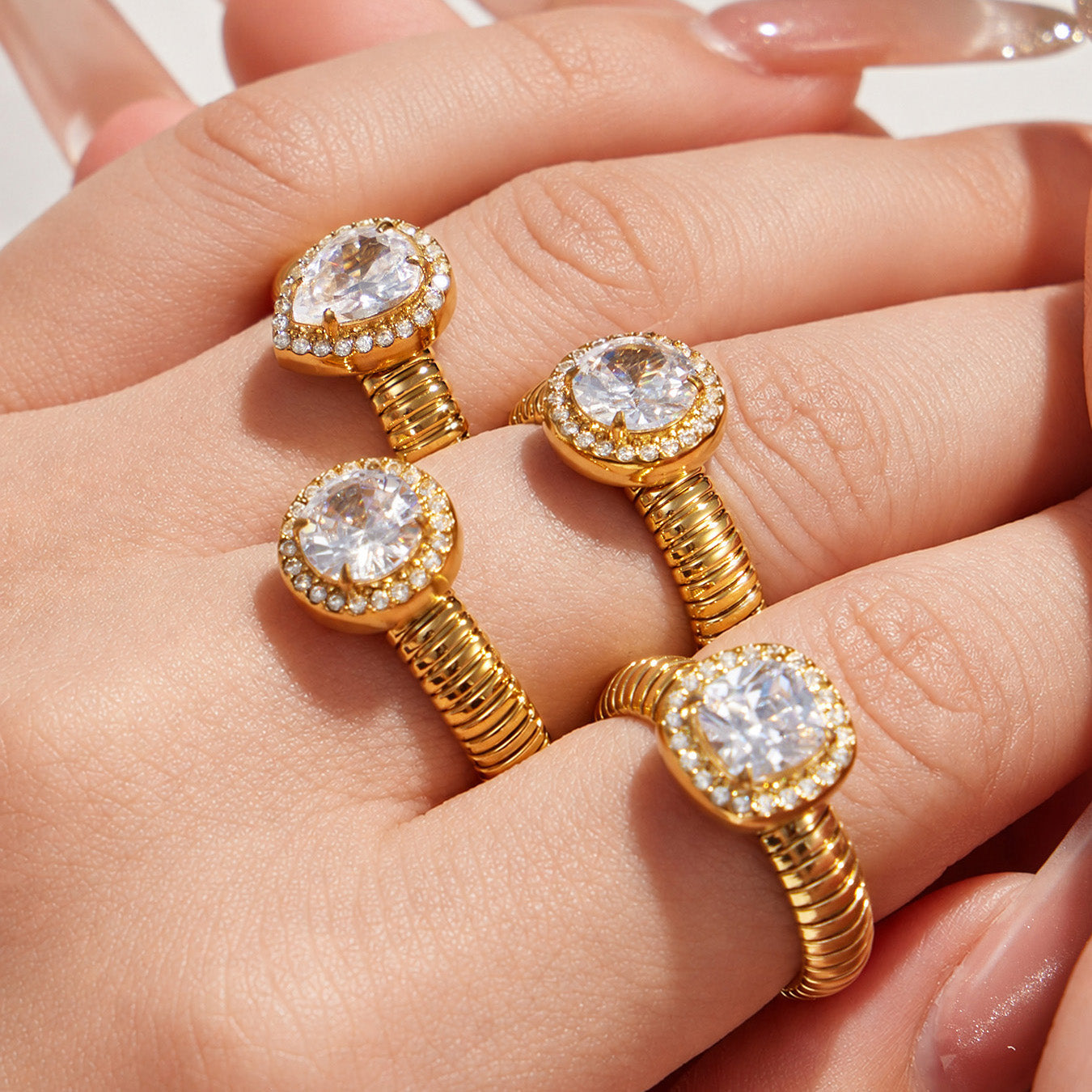 Model wearing gold geometric zircon open rings with waterdrop, round and square 5A zircon designs