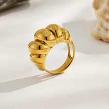 Side view of a gold tone sculptural 316L stainless steel statement ring