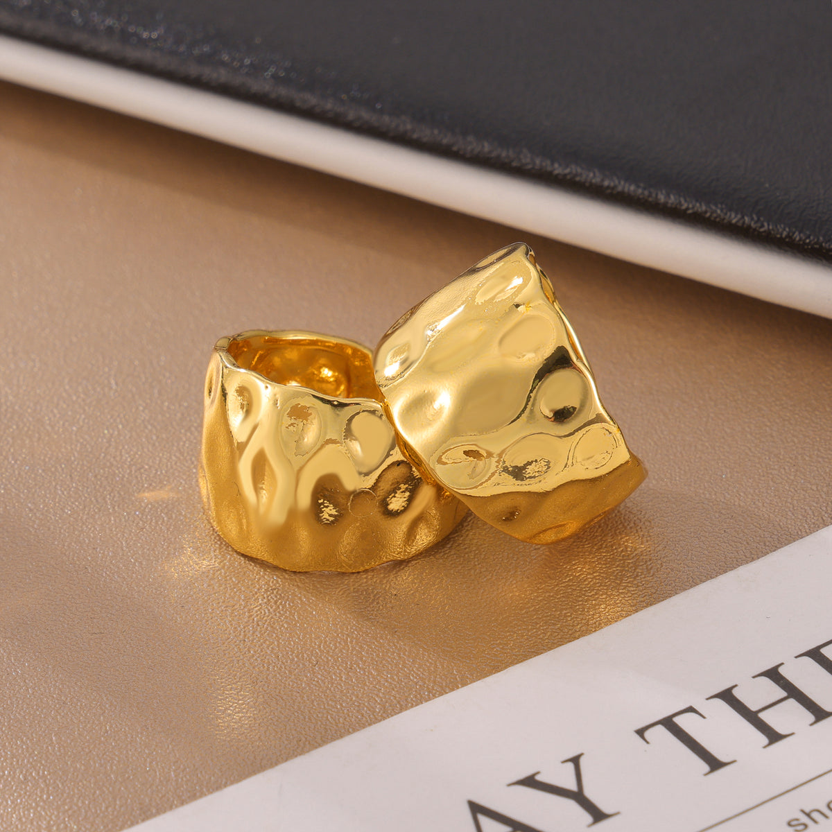 Gold sculptural open ring with organic hammered surface close-up