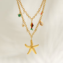Gold sea life necklace with starfish pendant, faux pearl and colorful charm details