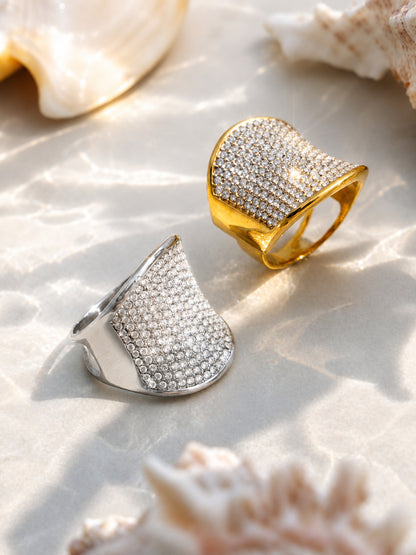 Gold and silver CZ wide band rings displayed with shells for resort shop and wholesale jewelry styling