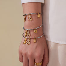 Gold & silver ocean shell/octopus bangle stack on wrist, trendy INS accessory