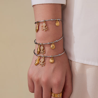 Gold & silver ocean shell/octopus bangle stack on wrist, trendy INS accessory