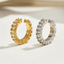 Gold and silver pavé zirconia ear cuffs displayed upright, showing contrasting metal finishes and open shapes