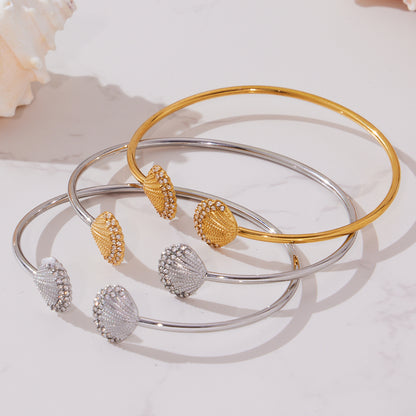 gold silver shell diamond cuff bracelets displayed on marble, stacked versatile style