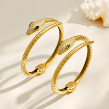 Gold snake open bangle displayed in two positions to show the sculpted serpent design