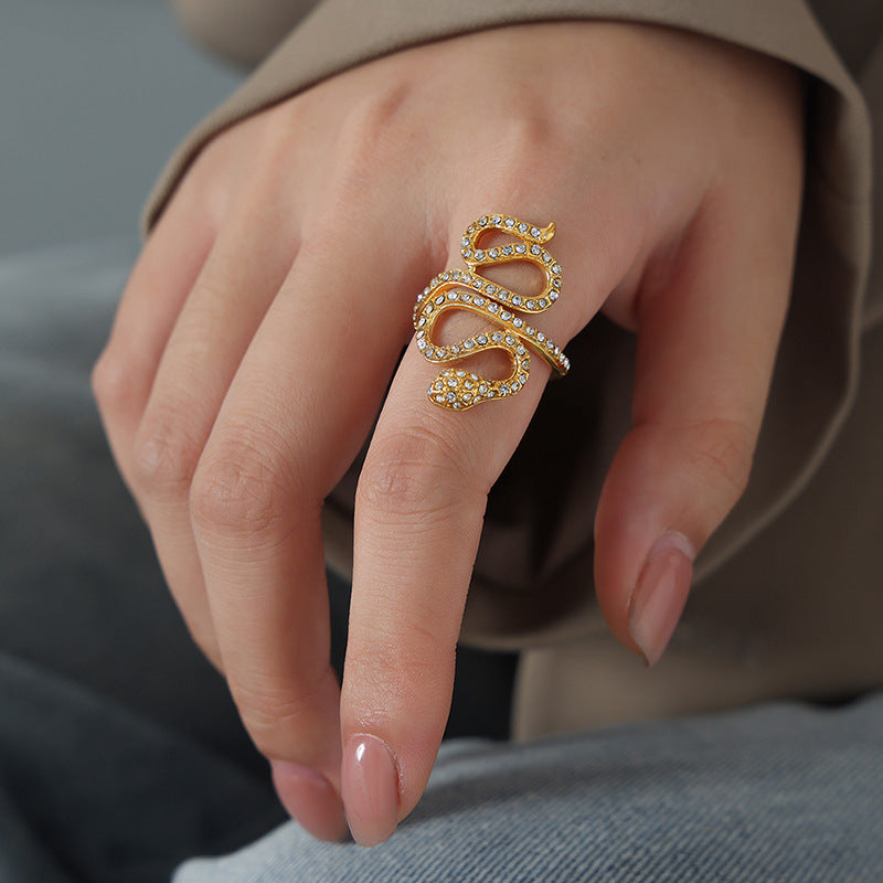 Close-up of a model wearing a gold snake open ring with clear cubic zirconia