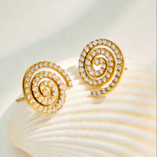 Gold spiral stud earrings displayed with pavé cubic zirconia details