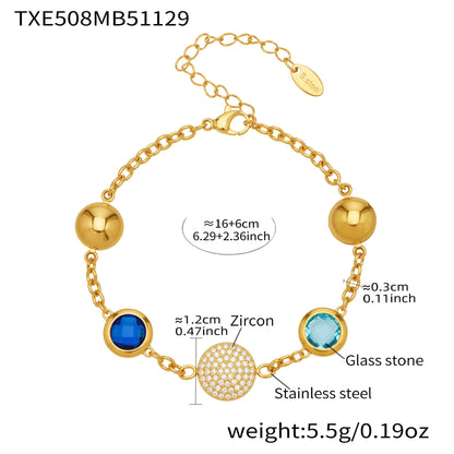 Gold stainless steel charm bracelet with blue glass stones and pavé zircon center