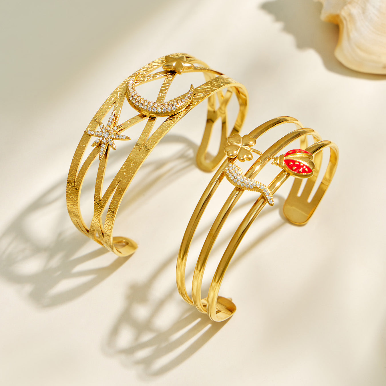 Gold star moon and red chili pepper cuff bracelet designs displayed side by side