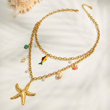 Gold starfish charm necklace with colorful sea life accents flat lay