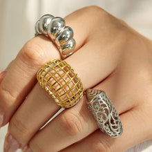 Model wearing gold and steel tone 316L stainless steel statement rings in mixed sculptural styles