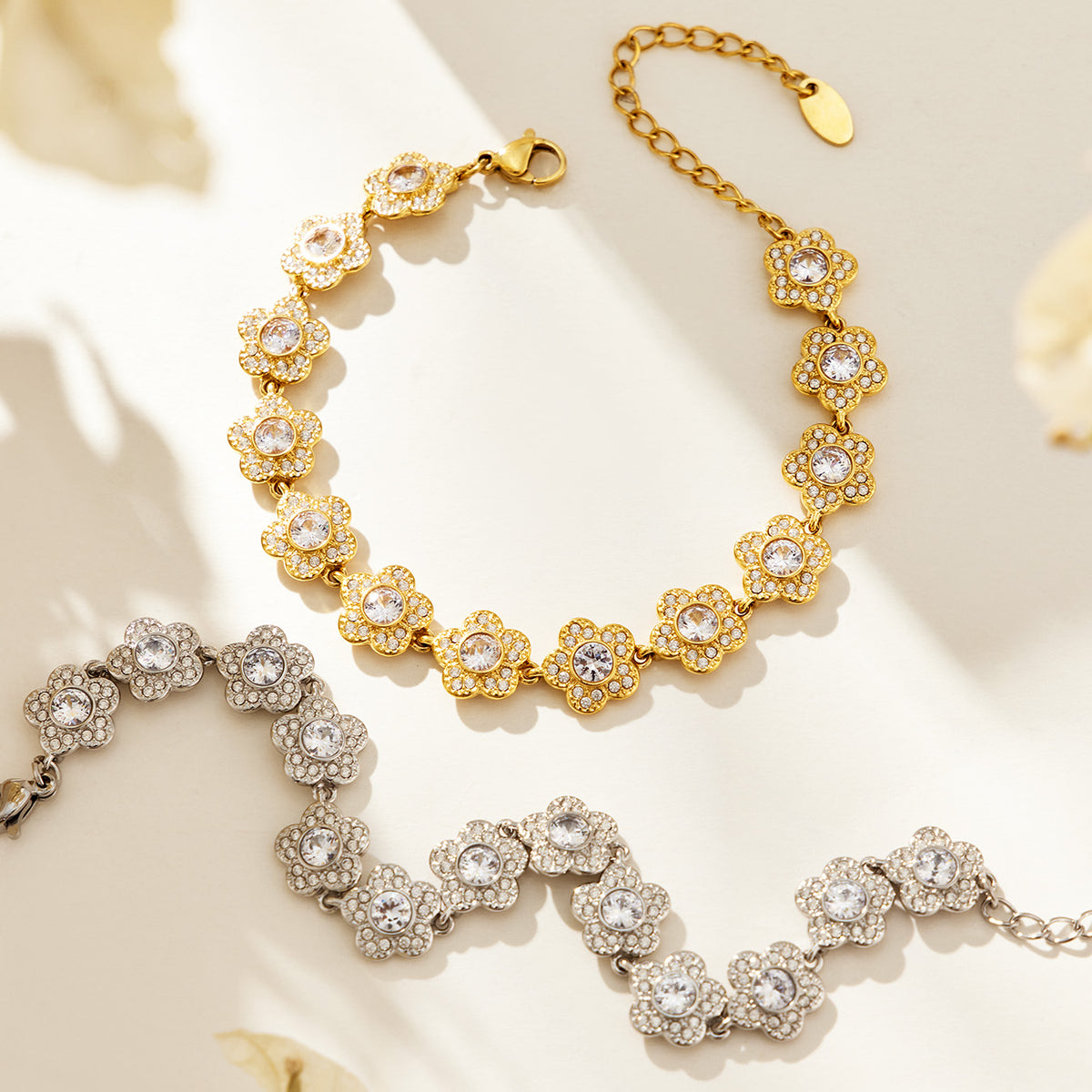 Gold-tone and steel-tone cubic zirconia flower bracelets displayed together