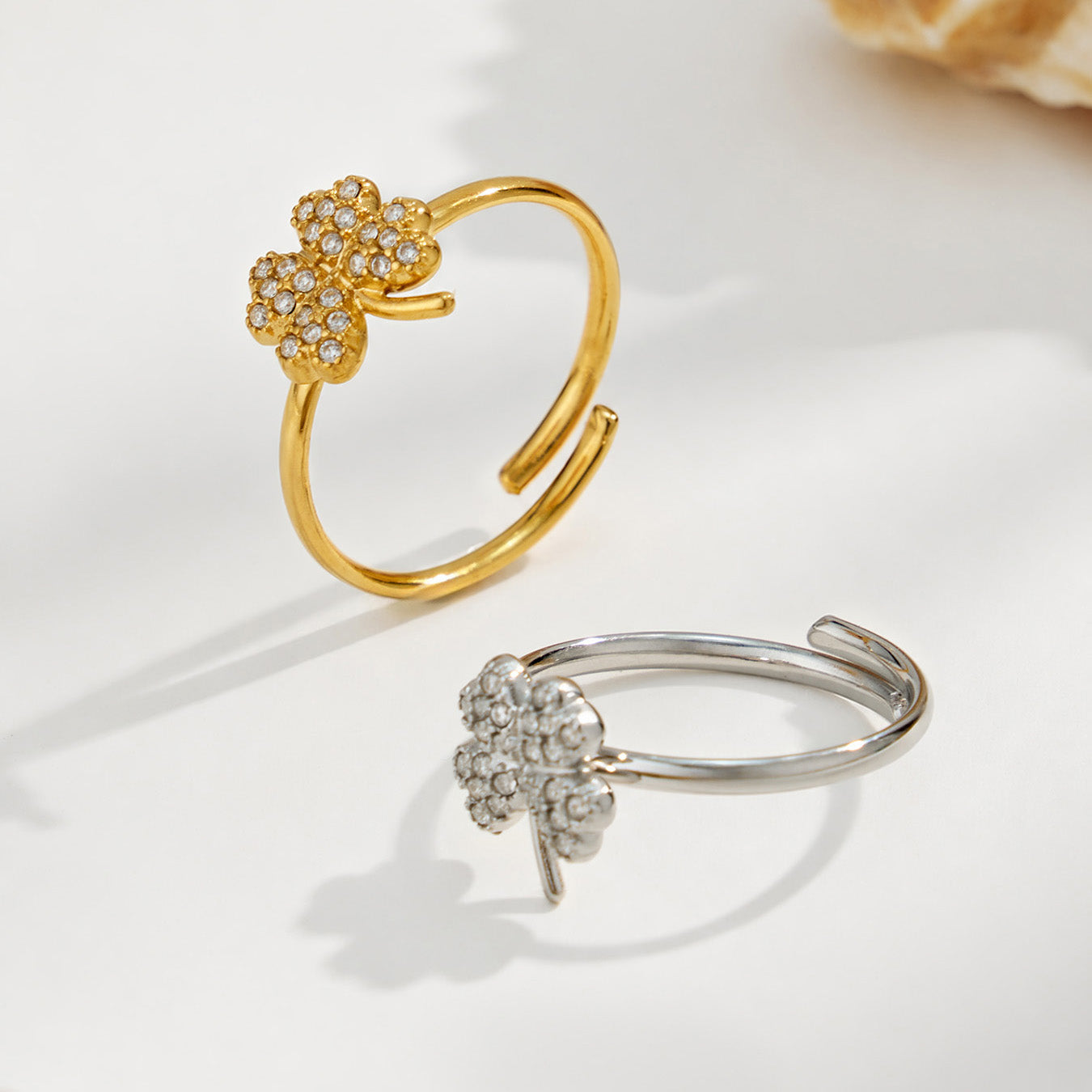 Gold and steel 316L stainless steel floral CZ open rings displayed together on a light background