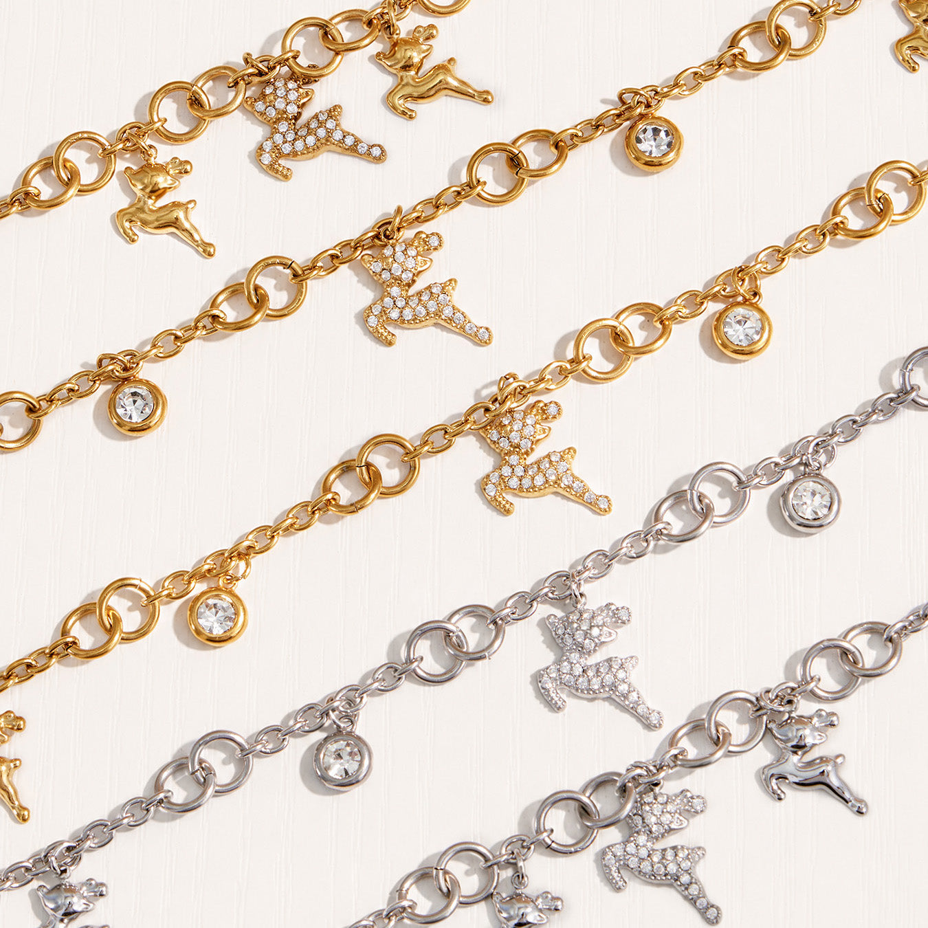 Detailed view of gold and polished steel reindeer necklace and bracelet chains