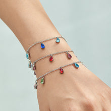 Gold-tone and steel-tone teardrop zircon bracelets styled together
