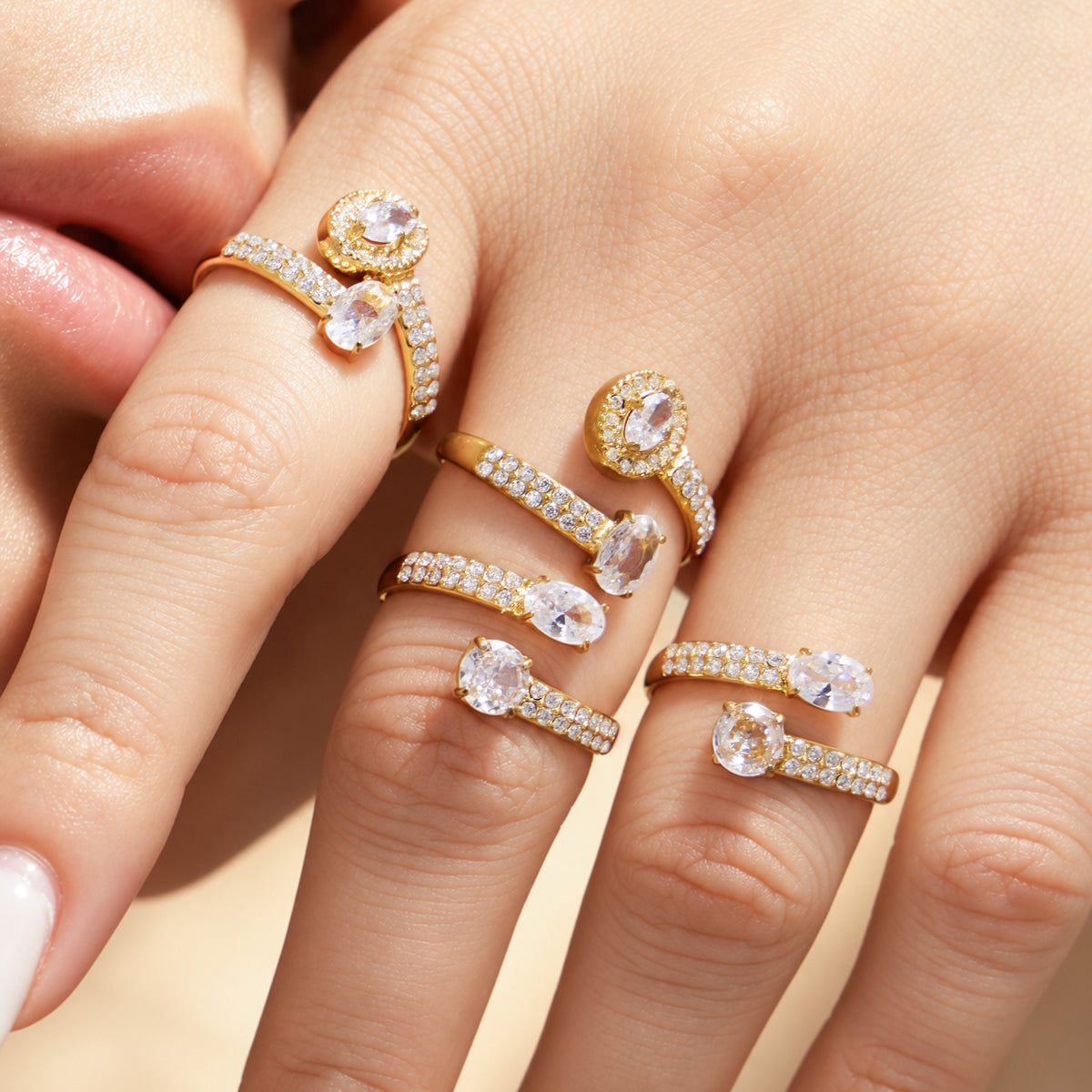 Gold-tone and steel-tone stainless steel CZ open rings styled together on hand