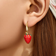Model wearing gold strawberry cubic zirconia drop earrings