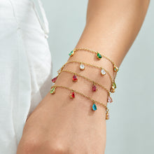 Gold-tone teardrop zircon bracelets in several colors styled on the wrist
