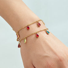Two gold-tone teardrop zircon bracelets layered on the wrist
