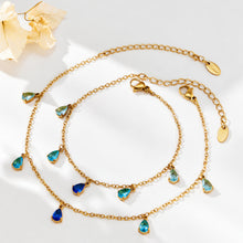 Two gold-tone teardrop zircon chain pieces displayed with clasp and extension chains