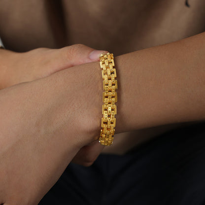 Gold 316L stainless steel lobster clasp bracelet on male wrist, minimalist design, waterproof, hypoallergenic, perfect for streetwear and fashion boutiques