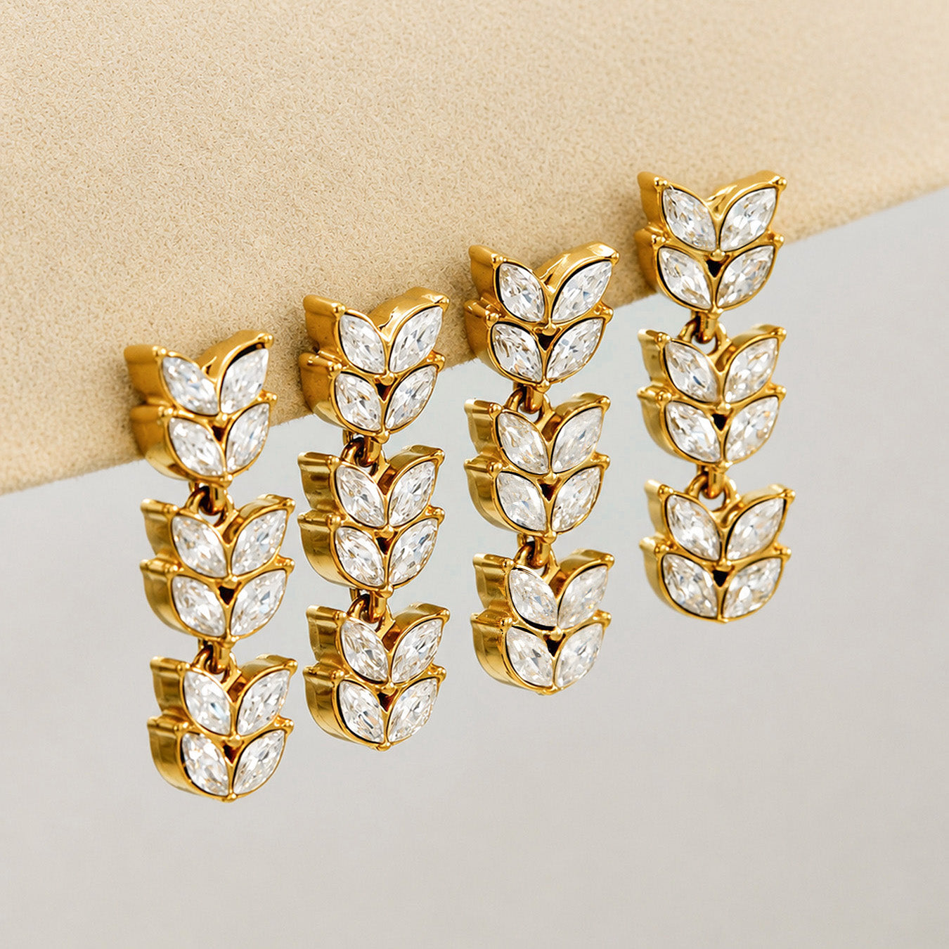 Gold wheat motif drop earrings displayed in multiple pairs