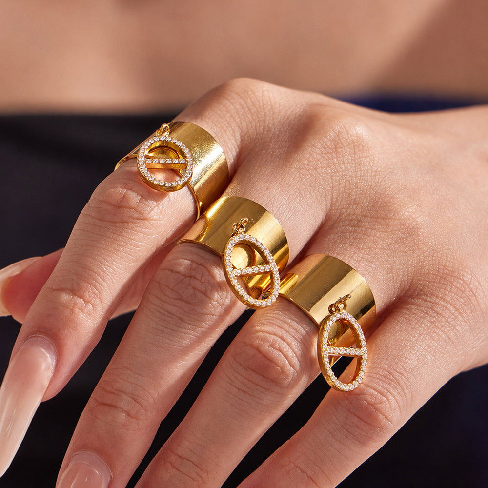 Fashion close-up of gold CZ pendant open ring worn on hand for statement jewelry displays