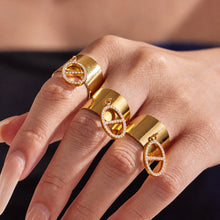 Fashion close-up of gold CZ pendant open ring worn on hand for statement jewelry displays