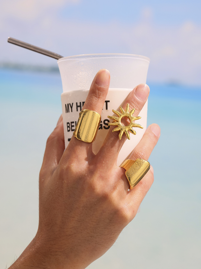 18K PVD gold wide band ring and sunburst ring styled with vacation drink by the sea