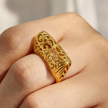 Gold tone wide cage-style 316L stainless steel ring worn on a model hand
