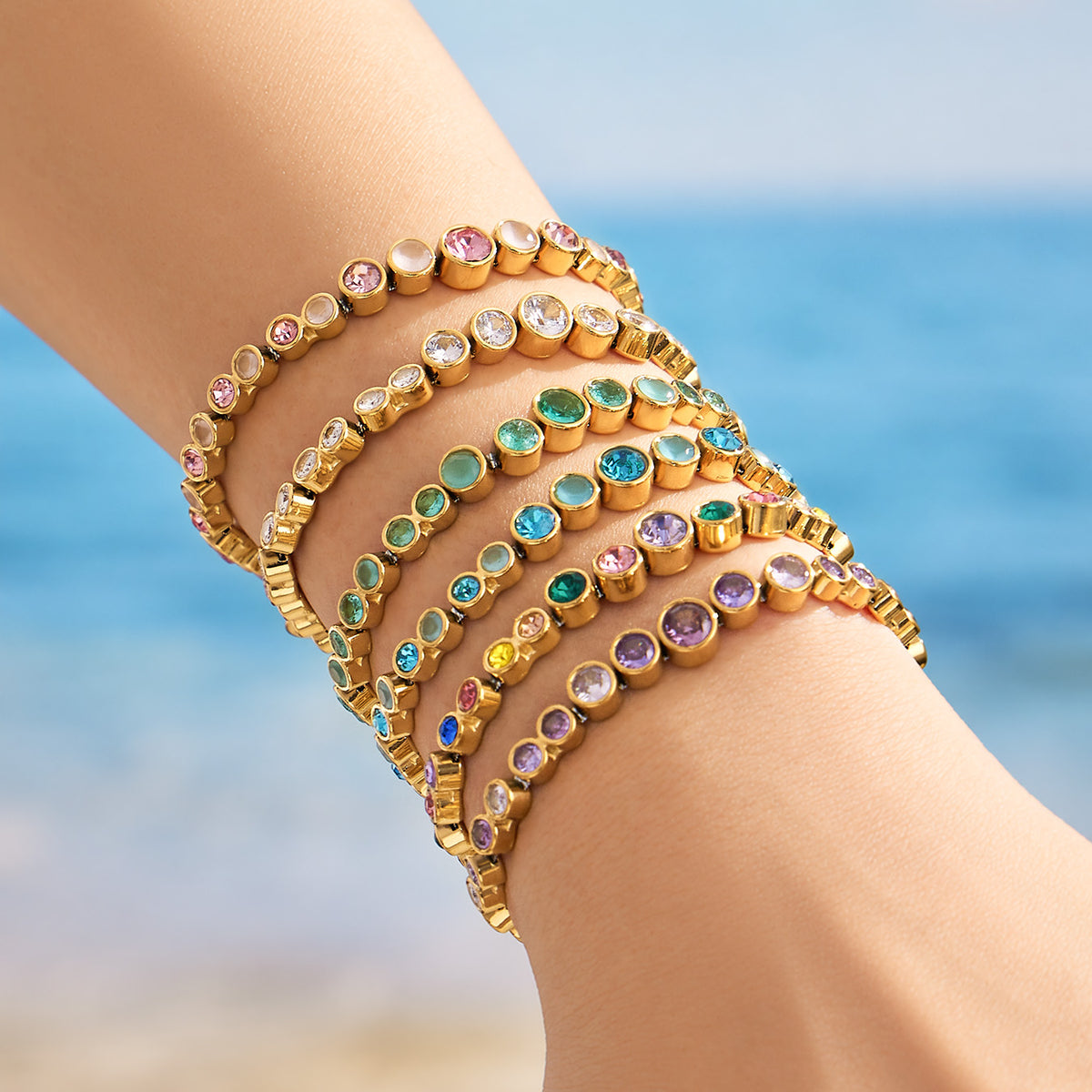 Gold zircon bracelets layered together