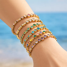 Gold zircon bracelets layered together