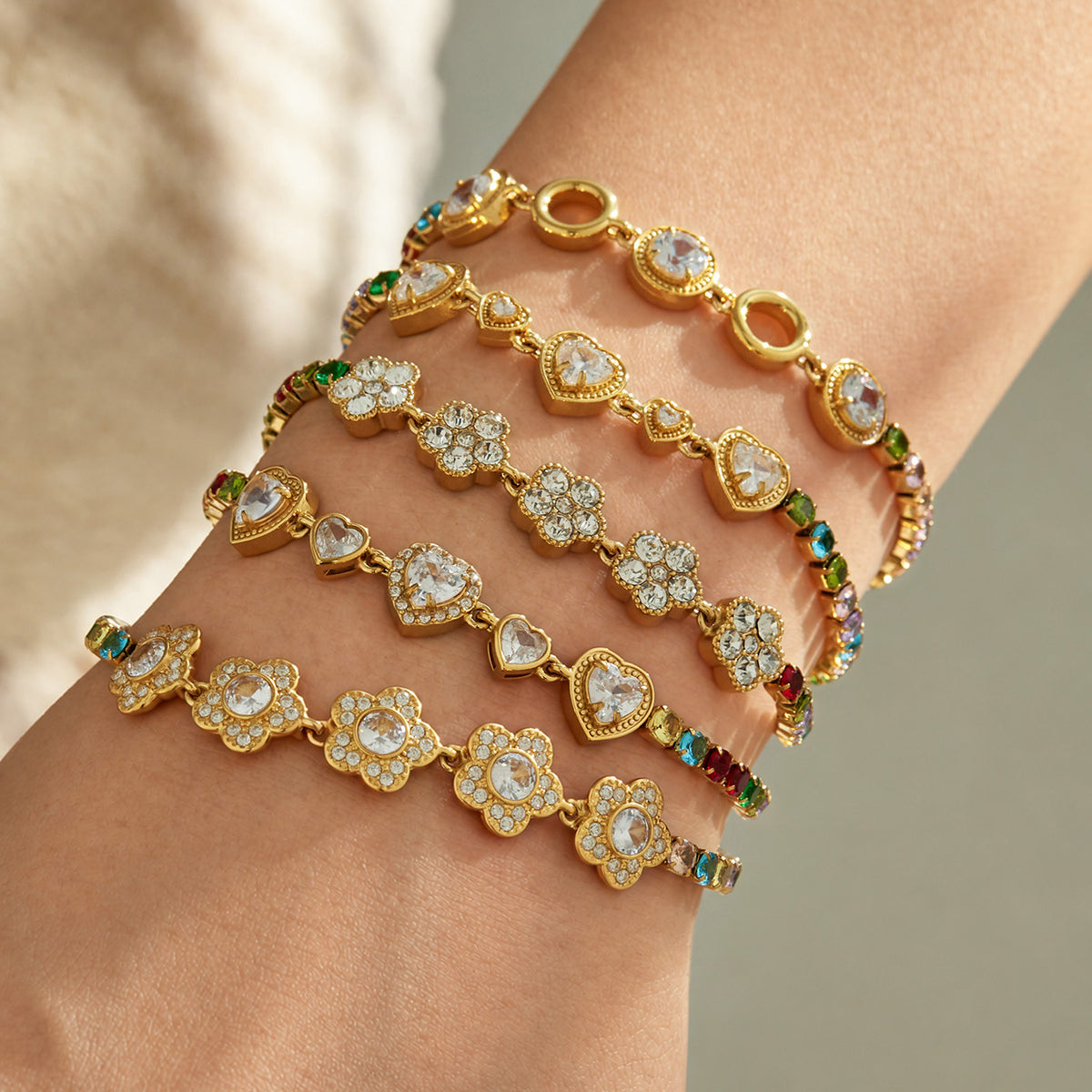 Gold zircon bracelets layered on wrist