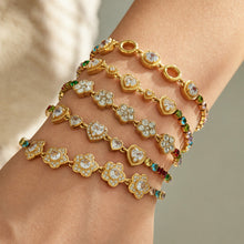 Gold zircon bracelets layered on wrist