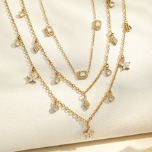 Gold zircon charm necklaces and bracelets arranged for boutique wholesale jewelry display