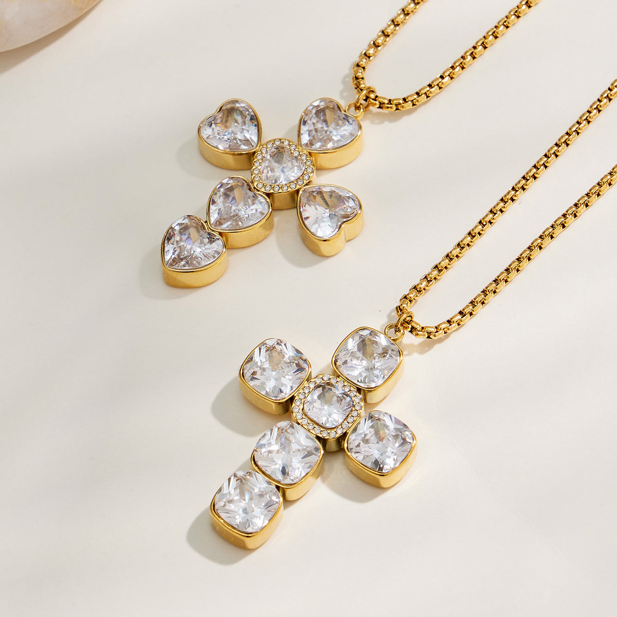 Gold zircon cross pendant necklaces in square and heart styles flat lay
