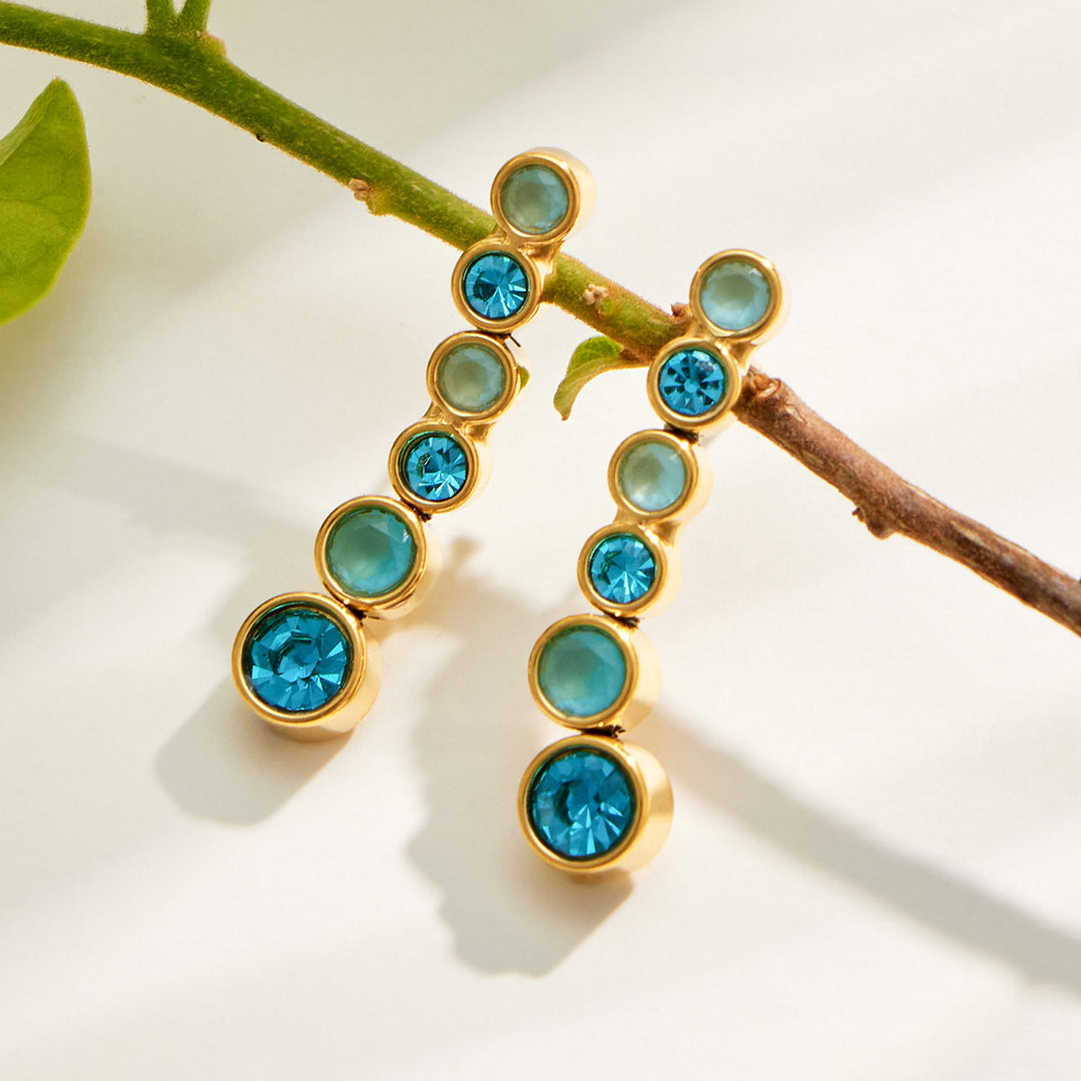 Gold zircon drop earring detail