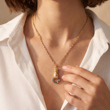 Gold-tone stainless steel zircon pendant necklace worn on a model