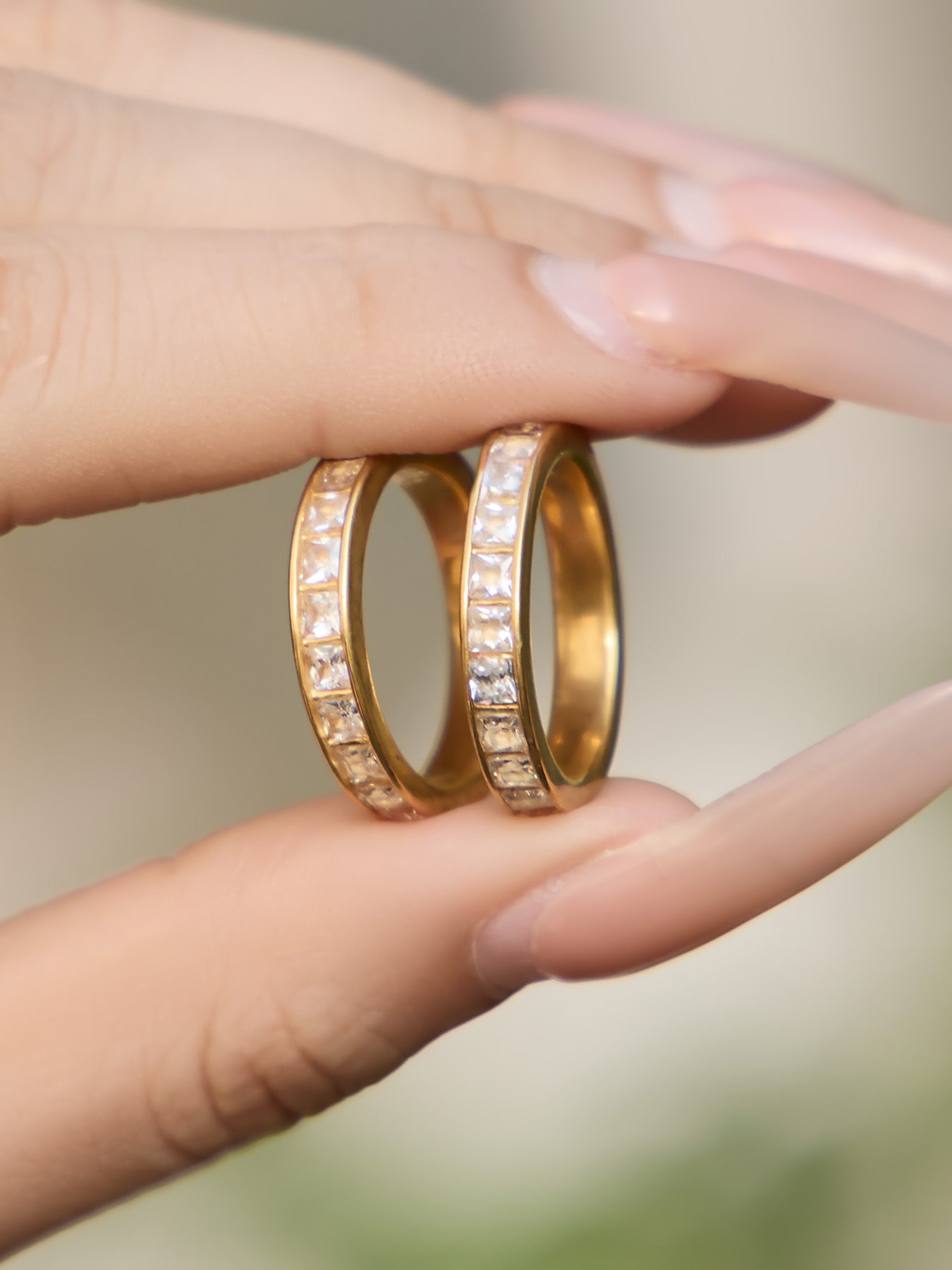 Product detail of gold zircon ring showing stainless steel construction and gemstone design